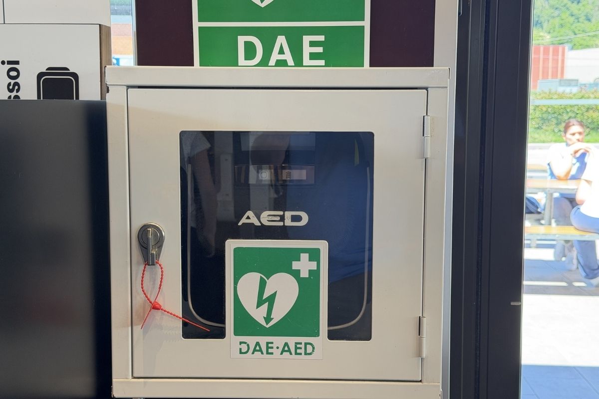 Public Automated External Defibrillator (AED) mounted in an outdoor cabinet, clearly marked for emergency use in public spaces.
