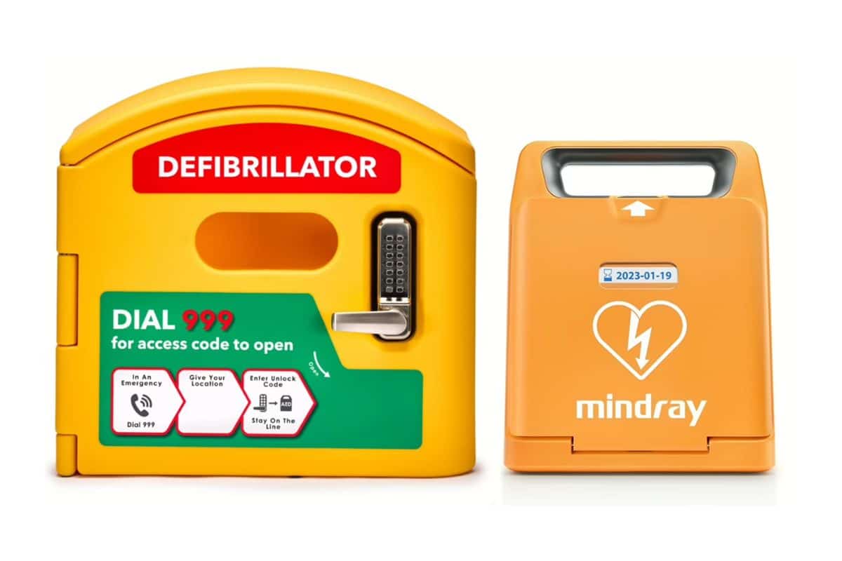 An orange C1A Mindray defibrillator next to a yellow defibrillator case with a PIN entry handle.