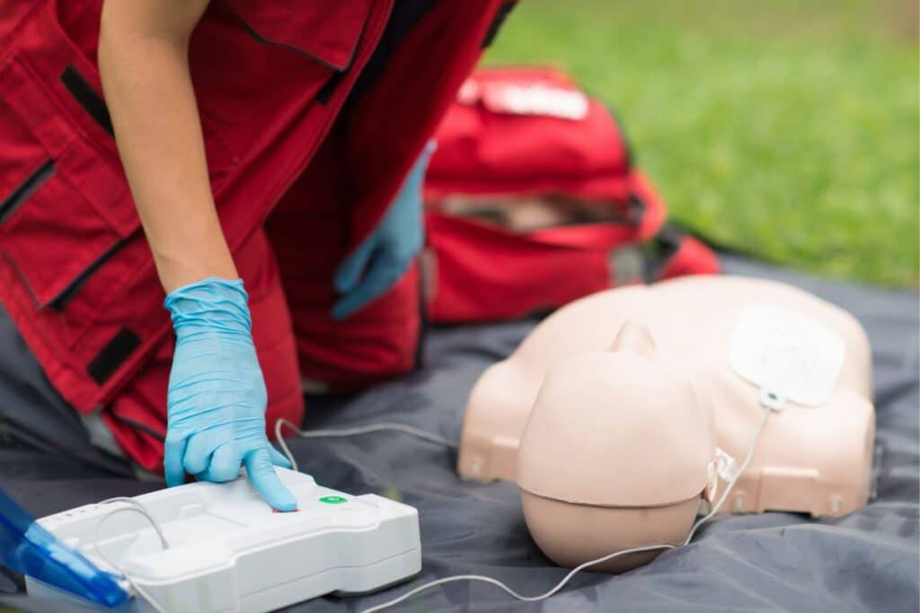 AED defibrillator training on a manikin.