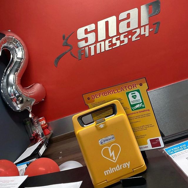 A Mindray defibrillator placed on a counter at Snap Fitness gym, highlighting the importance of AEDs in fitness centers for cardiac emergencies.