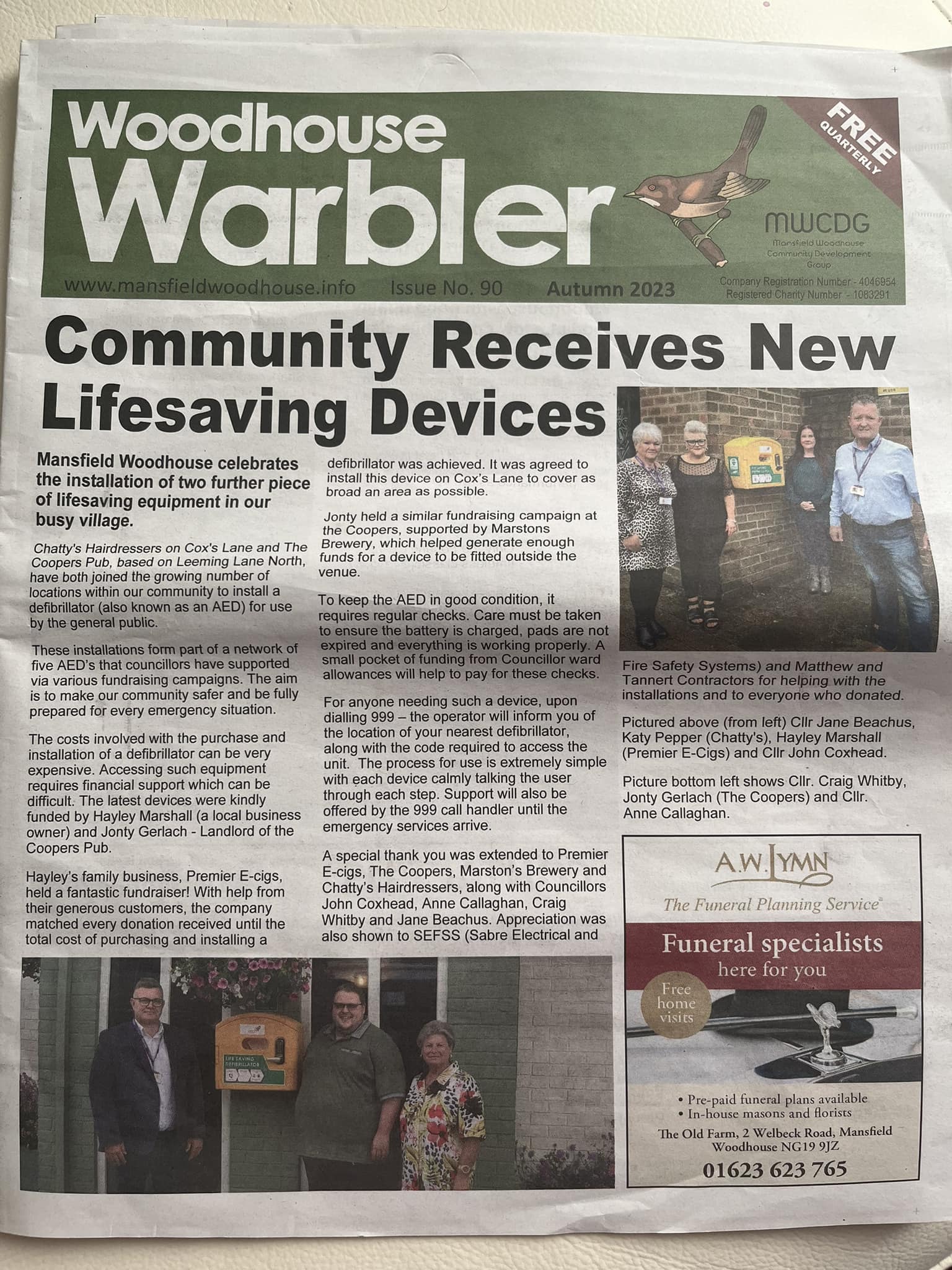 Woodhouse Warbler newspaper article highlighting the installation of new community defibrillators in Mansfield Woodhouse, supported by local businesses and councillors.