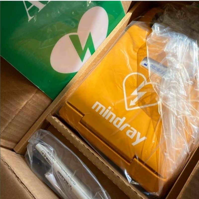 New Mindray AED defibrillator unpacked, showcasing the device and accessories, ready for deployment in emergency situations.