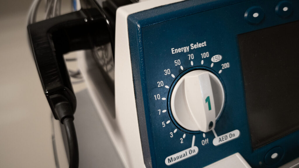 Close-up of the energy select dial on a defibrillator, indicating the settings for different energy levels, crucial for controlling shock intensity during defibrillation. This image highlights the importance of selecting the appropriate energy level for effective treatment during a cardiac emergency.