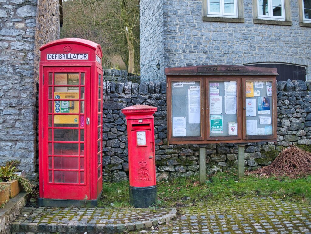 Defibrillator in a red phone box in a village, highlighting AEDs in unexpected places across the UK.