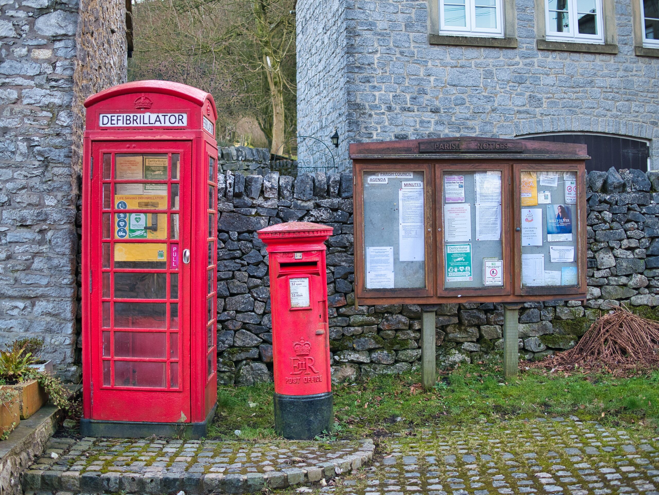 Defibrillator in a red phone box in a village, highlighting AEDs in unexpected places across the UK.