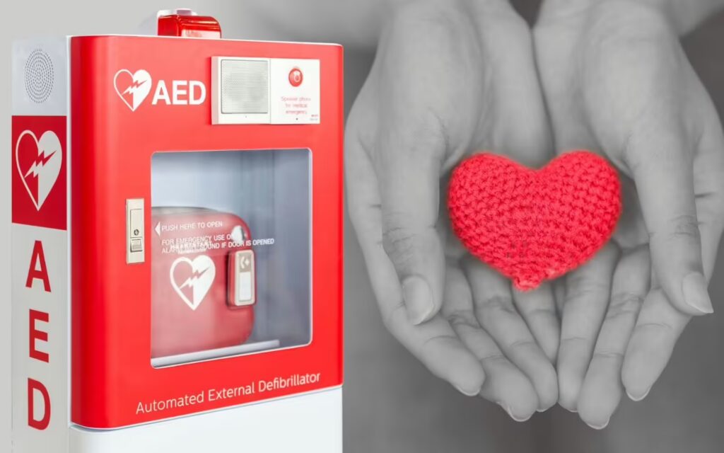 Close-up of an AED defibrillator cabinet with a heart symbol, highlighting its role in providing immediate access to life-saving technology during cardiac emergencies.
