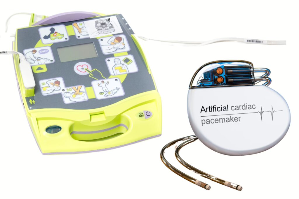 iPAD AED defibrillator next to a cardiac pacemaker device, comparing two life-saving heart devices.